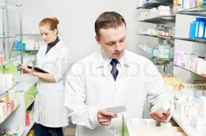 Confident pharmacy chemist man in drugstore