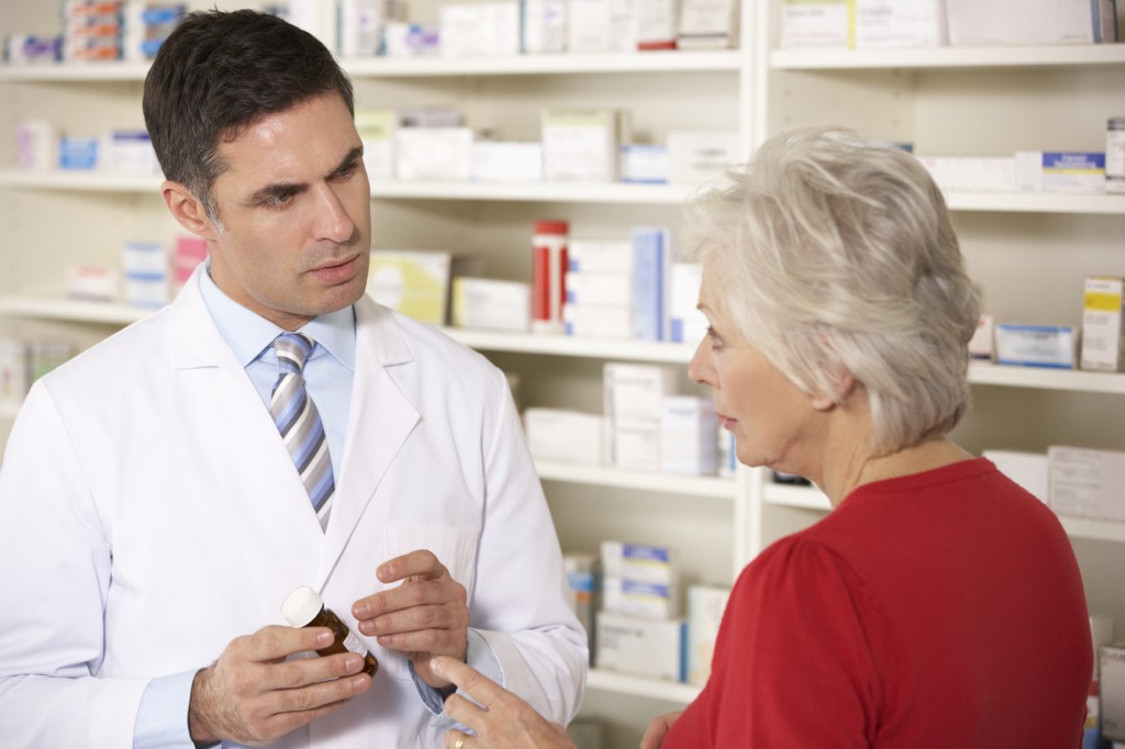 American pharmacist with senior woman in pharmacy